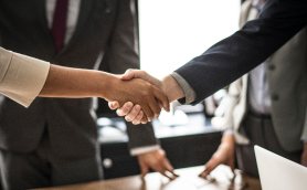 business-people-shaking-hands-in-a-meeting-room-1